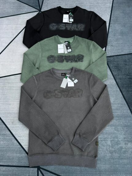 JzYkb350650 Logo Sweater by G-Star RAW. These sweatshirts feature a ribbed crew neckline, ribbed cuffs and hem, and a graphic "G-STAR" print with a distressed effect on the front